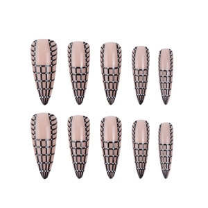 Long stiletto false nails with pink base, black grid patterns and white polka dots