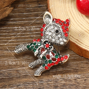 Detail view of a luxury deer brooch with red and green crystals including size dimensions