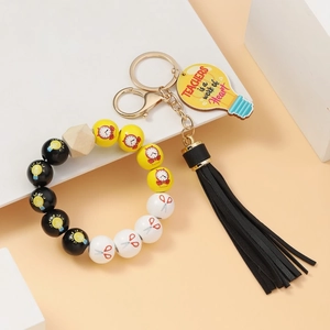 Detail of colorful beaded keychain bracelet with black tassel and wooden teacher gift tag