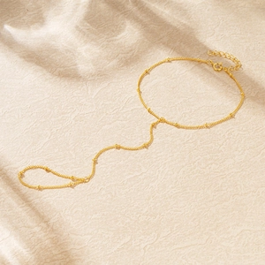 Detailed macro view of gold plated 925 silver finger bracelet with small beads