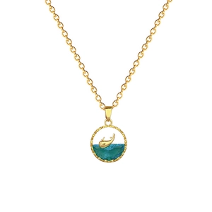 Elegant whale pendant necklace with blue crystal and gold-plated chain on white background