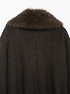 Detail of dark brown woolen jacket featuring a plush faux fur collar and back seam design