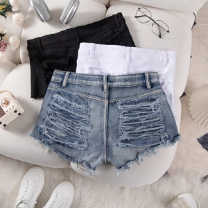 Detail view of denim shorts with distressed back design and raw hem in three colors