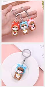 Detailed view of three cute cartoon Shiba Inu keychains in deer, monster and bunny outfits