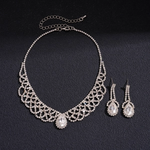 Detail of silver necklace set with white rhinestones and large pear-cut crystal charms