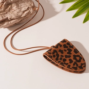 Macro shot of faux leather leopard print glasses case necklace with fine stitching detail