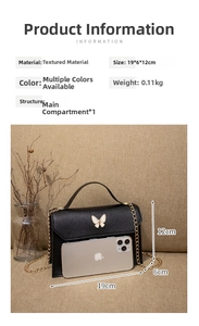 Detailed view of butterfly handbag dimensions 19x6x12cm with gold chain and black texture