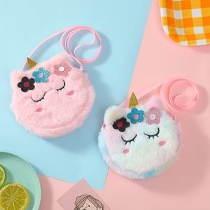 Detail view of plush unicorn crossbody bags in pink and pastel gradient colors