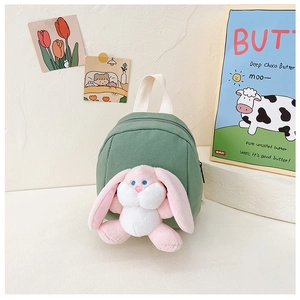 Detail of green canvas toddler backpack with cute plush bunny and top carry handle