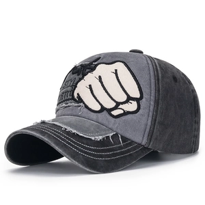 Detail view of washed cotton baseball cap with fist embroidery and distressed frayed edges