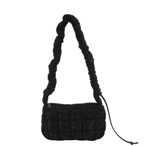 Minimalist black quilted cloud bag with pleated shoulder strap and textured finish