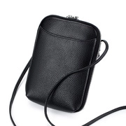 Detailed view of black litchi pattern leather texture and metal zipper on crossbody bag