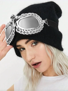 Detail of black knit beanie featuring silver metal chain goggles accessory on a model