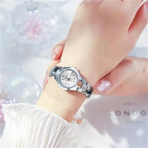 Gros plan d'une montre à quartz argentée avec détail diamant et affichage de date