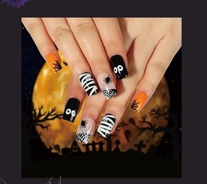 Halloween press-on nails with spider web, mummy and cartoon eye designs on long square tips