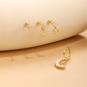 Detailed shot of S925 sterling silver gold earrings with opal stones and star heart studs