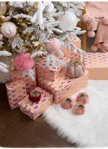 Pink Christmas gift boxes with gold bows and velvet pumpkins for festive scene decoration
