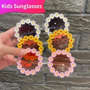 Children's daisy sunglasses with UV400 protection in white, yellow, and pink colors