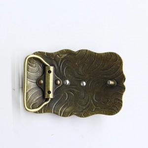 Macro detail of retro bronze belt buckle back with wave relief and pin closure