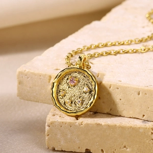 18K gold plated necklace featuring a hammered disk pendant with pink and white cubic zirconia