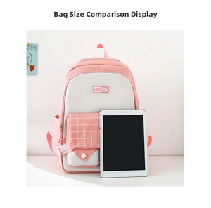 Detailed view of pink and white patchwork backpack with grid pocket and tablet for scale