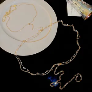 Elegant gold body chain necklace with zircon beaded tassels on white and black background