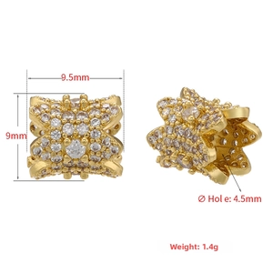 Macro view of gold-tone tube bead with pavé cubic zirconia showing 9.5x9mm dimensions