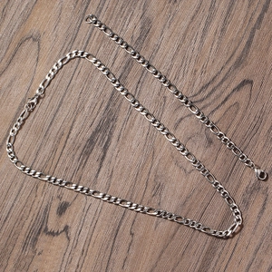 Close-up of 5mm stainless steel Figaro chain necklace with secure lobster clasp detail