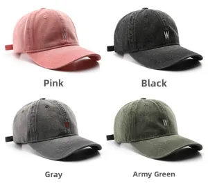 Close-up of four washed cotton baseball caps in pink, black, grey, and olive with W embroidery