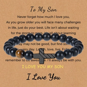 Detail of beaded bracelet with American flag cross and tiger eye stone on gift card