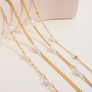Detailed view of layered 18k gold plated stainless steel necklaces with freshwater pearls