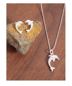 Close-up of S925 sterling silver dolphin pendant necklace and matching stud earrings set