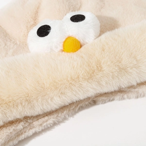 Cute bird-themed plush earflap hat in beige with cartoon eyes and yellow nose detail