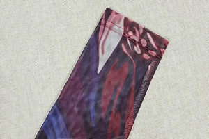 Close-up of mesh fabric texture and high-quality stitching on retro print bodycon dress