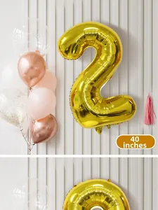Detail of a 40-inch golden number 2 foil balloon with assorted pink latex party balloons