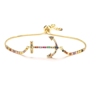 Gold chain bracelet featuring a colorful zircon anchor pendant and adjustable slider clasp