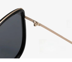 Macro shot of durable gold metal hinge on premium black frames for smooth temple folding