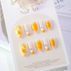 Short almond press-on nails with yellow gradient, 3D white flowers and tiny rhinestones
