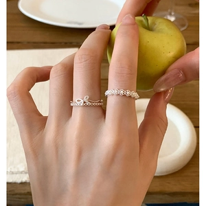 Elegant silver bow and lace floral open rings set worn for a minimalist luxury look