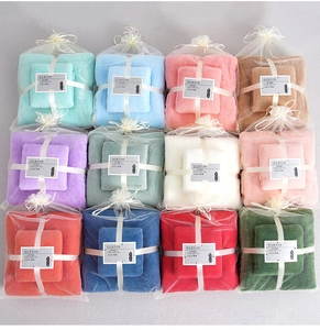 Detailed grid of 12 colorful coral fleece towel sets in elegant sheer drawstring pouches