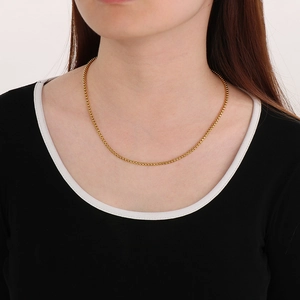 Classic gold stainless steel pearl chain necklace worn by a model on a white background