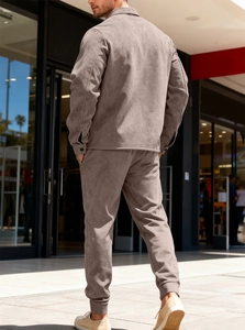 Rear view of men's casual suede jacket and joggers set in a stylish urban outdoor setting