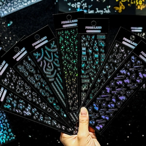 Holographic laser stickers featuring stars and pixel icons with aurora reflections