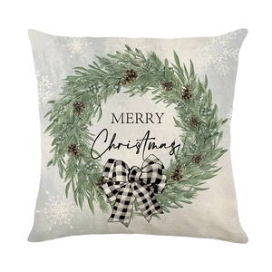 Christmas wreath pillow cover with plaid bow and Merry Christmas text on blue background