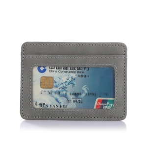 Detailed view of gray PU leather passport holder with a transparent ID card window