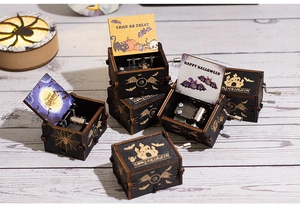 Close-up of Halloween wooden music box with pumpkin prints and trick or treat message