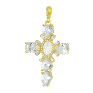 Macro shot of gold cross pendant with cubic zirconia and white shell Virgin Mary icon