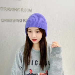 Detailed knit texture and folded brim of a cozy purple winter beanie for cold weather