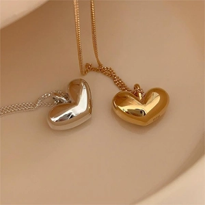 Close-up of S925 sterling silver heart pendants in gold and silver mirror finish