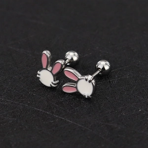 Macro detail of cute white rabbit enamel stud earrings with secure screw-back design